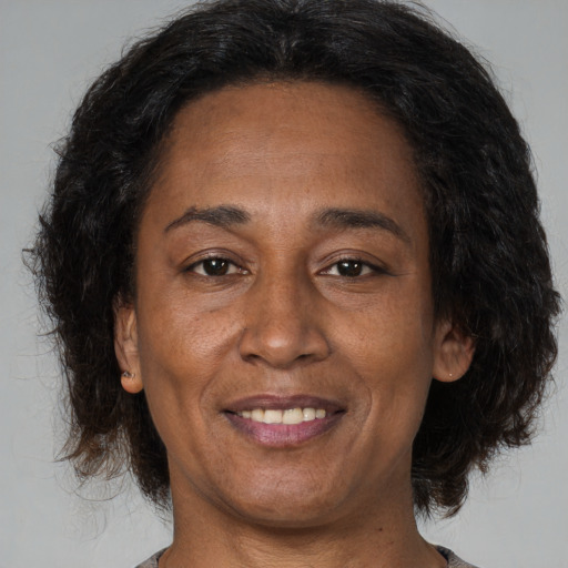 Joyful asian adult female with medium  brown hair and brown eyes