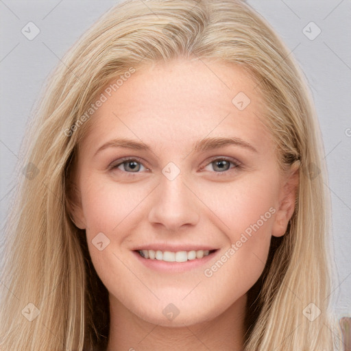 Joyful white young-adult female with long  brown hair and blue eyes