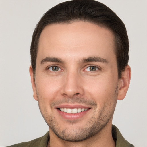 Joyful white young-adult male with short  brown hair and brown eyes