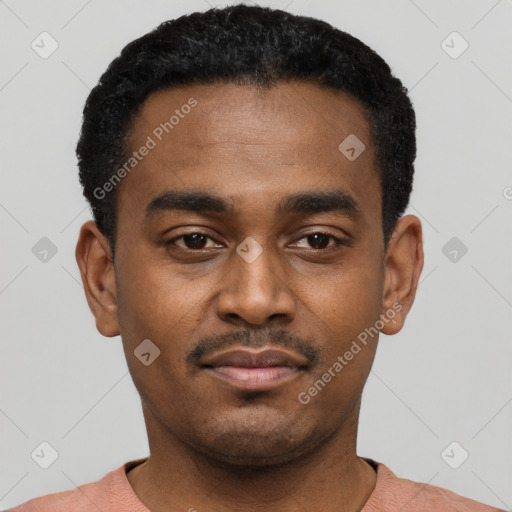 Joyful black young-adult male with short  black hair and brown eyes