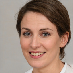 Joyful white adult female with medium  brown hair and brown eyes