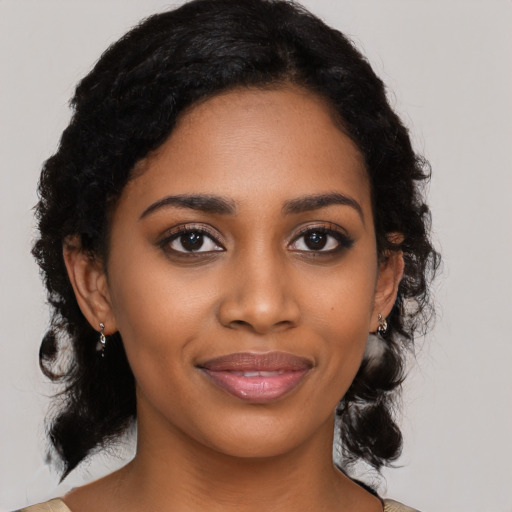 Joyful black young-adult female with medium  black hair and brown eyes