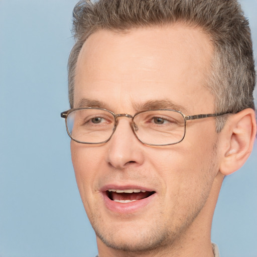 Joyful white adult male with short  brown hair and brown eyes