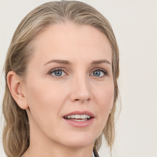 Joyful white young-adult female with medium  brown hair and blue eyes