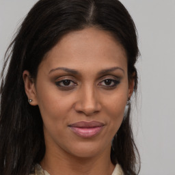 Joyful latino young-adult female with long  brown hair and brown eyes