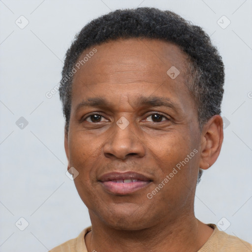 Joyful black adult male with short  brown hair and brown eyes