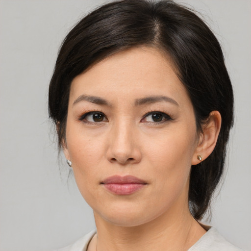 Joyful asian young-adult female with medium  brown hair and brown eyes