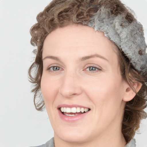 Joyful white young-adult female with medium  brown hair and blue eyes