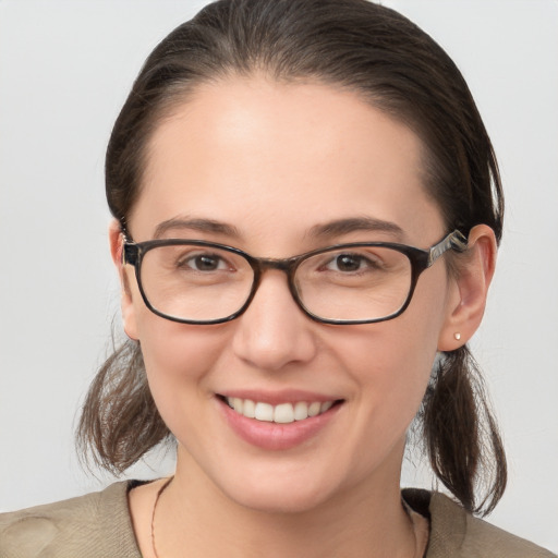 Joyful white young-adult female with medium  brown hair and grey eyes