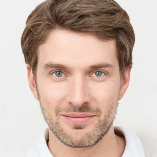 Joyful white young-adult male with short  brown hair and grey eyes