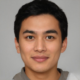 Joyful asian young-adult male with short  black hair and brown eyes