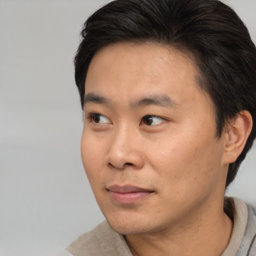Neutral asian young-adult male with short  brown hair and brown eyes