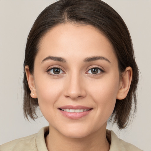 Joyful white young-adult female with medium  brown hair and brown eyes