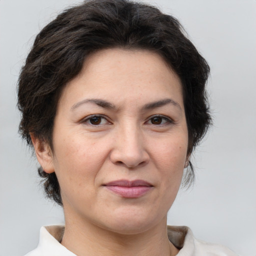 Joyful white adult female with short  brown hair and brown eyes