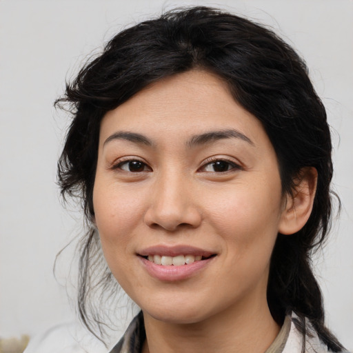 Joyful latino young-adult female with medium  brown hair and brown eyes