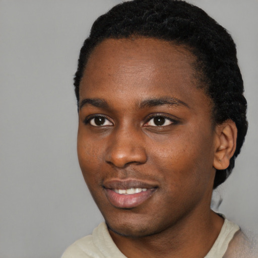 Joyful black young-adult male with short  black hair and brown eyes