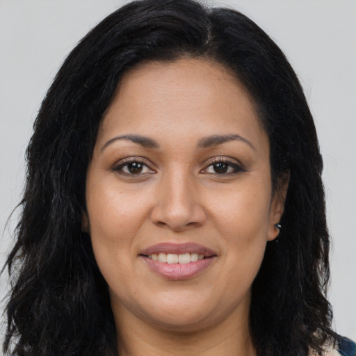 Joyful latino young-adult female with long  brown hair and brown eyes