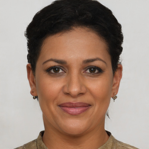 Joyful latino young-adult female with short  brown hair and brown eyes