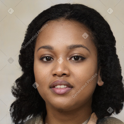 Joyful black young-adult female with long  black hair and brown eyes