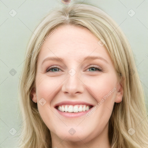 Joyful white young-adult female with long  brown hair and blue eyes