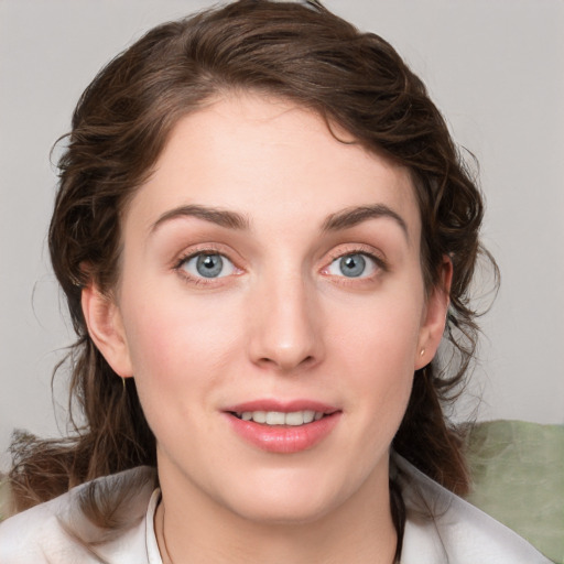 Joyful white young-adult female with medium  brown hair and blue eyes