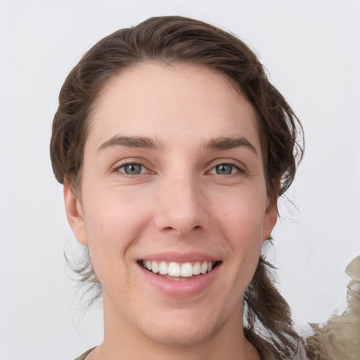 Joyful white young-adult female with medium  brown hair and grey eyes