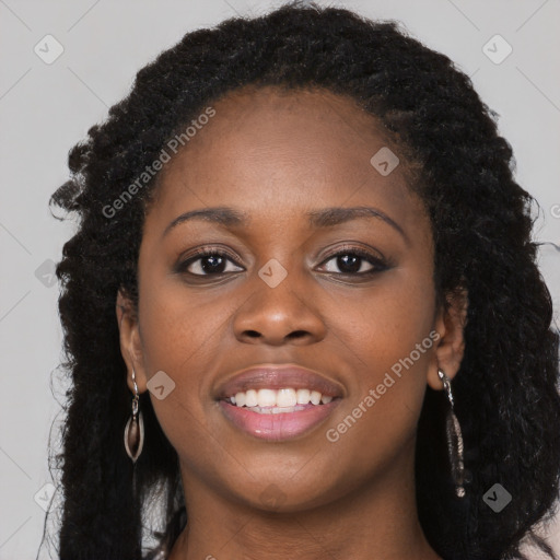 Joyful black young-adult female with long  black hair and brown eyes