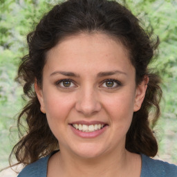 Joyful white young-adult female with medium  brown hair and green eyes