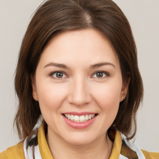 Joyful white young-adult female with medium  brown hair and brown eyes