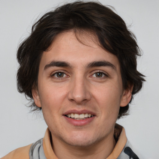 Joyful white young-adult male with medium  brown hair and brown eyes