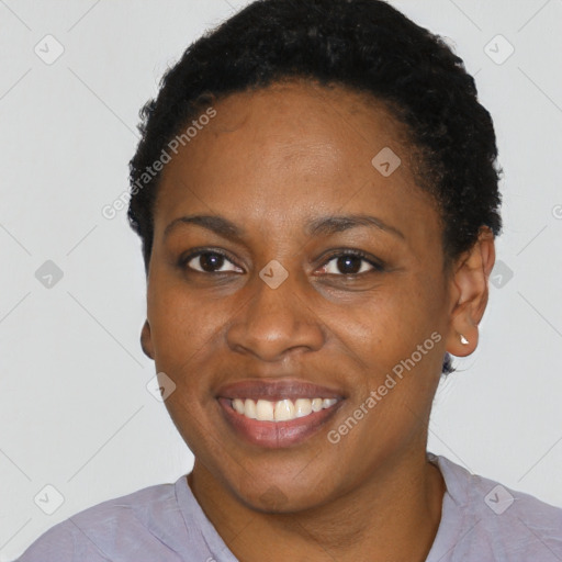 Joyful black adult female with short  brown hair and brown eyes