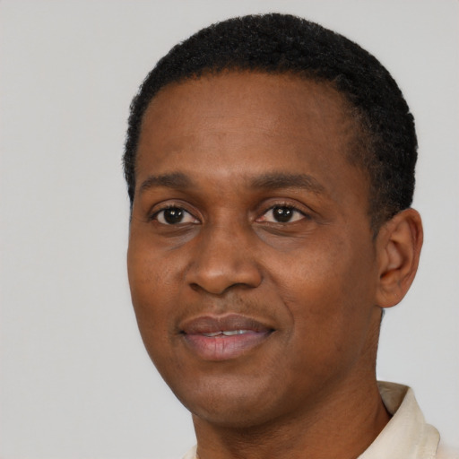 Joyful black young-adult male with short  black hair and brown eyes
