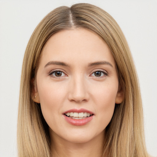 Joyful white young-adult female with long  brown hair and brown eyes