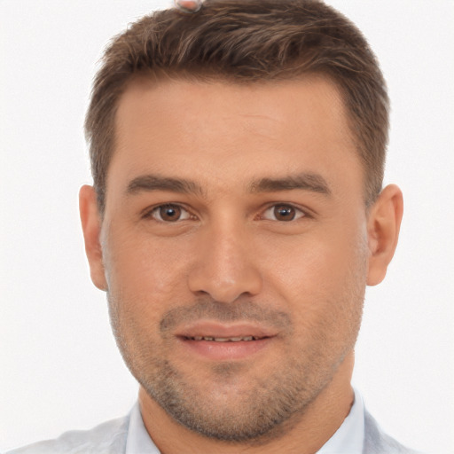 Joyful white young-adult male with short  brown hair and brown eyes