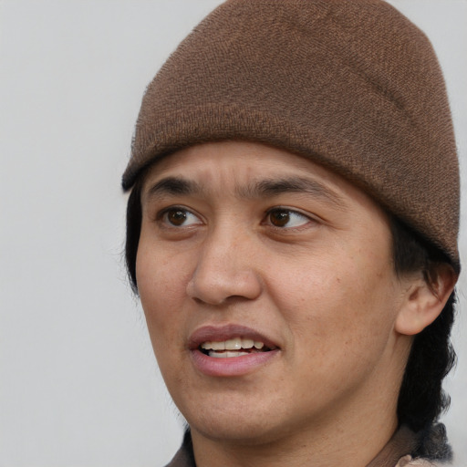 Joyful latino young-adult male with short  brown hair and brown eyes