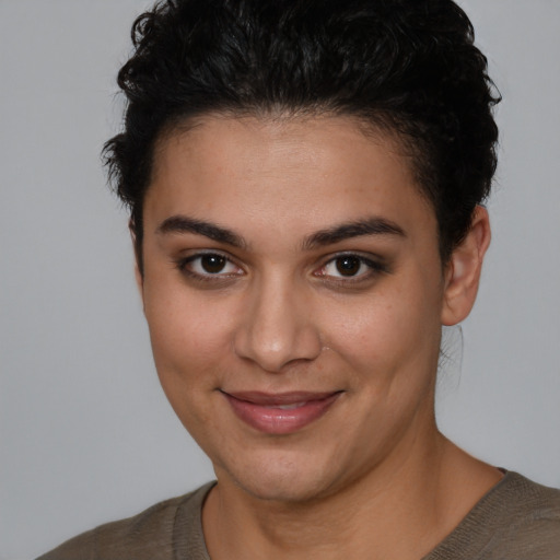 Joyful latino young-adult female with short  brown hair and brown eyes