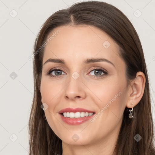 Joyful white young-adult female with long  brown hair and grey eyes