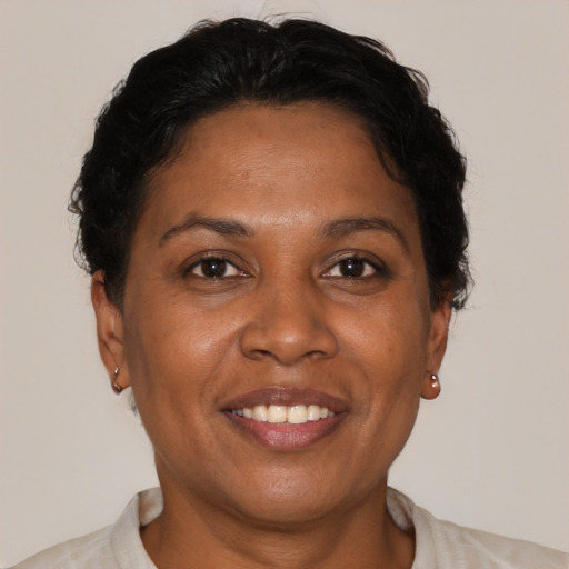 Joyful black adult female with short  brown hair and brown eyes