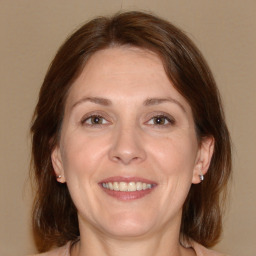 Joyful white adult female with medium  brown hair and brown eyes