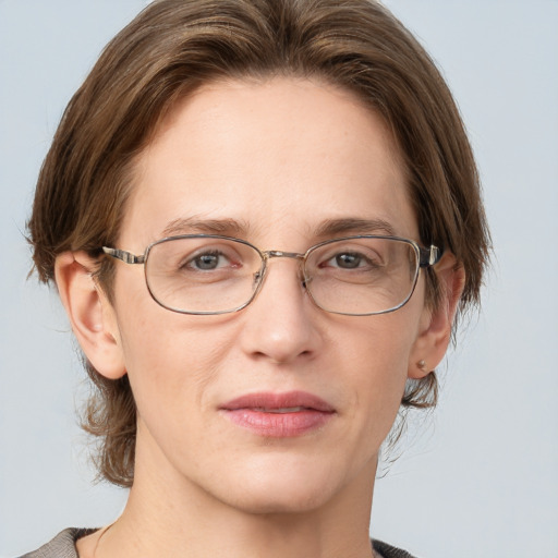 Joyful white adult female with medium  brown hair and grey eyes