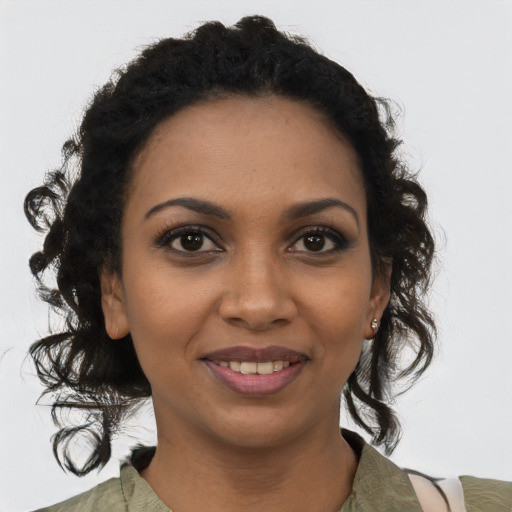 Joyful black young-adult female with medium  black hair and brown eyes