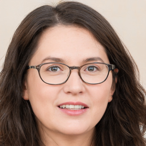 Joyful white adult female with long  brown hair and brown eyes