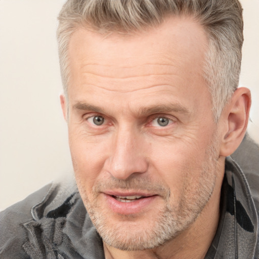 Joyful white middle-aged male with short  brown hair and brown eyes