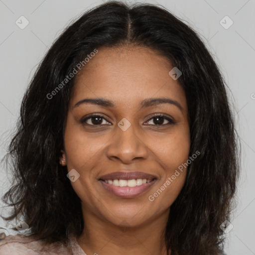 Joyful black young-adult female with long  brown hair and brown eyes