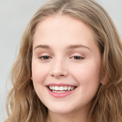 Joyful white young-adult female with long  brown hair and blue eyes