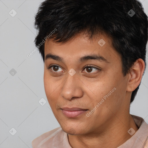 Joyful asian young-adult male with short  brown hair and brown eyes