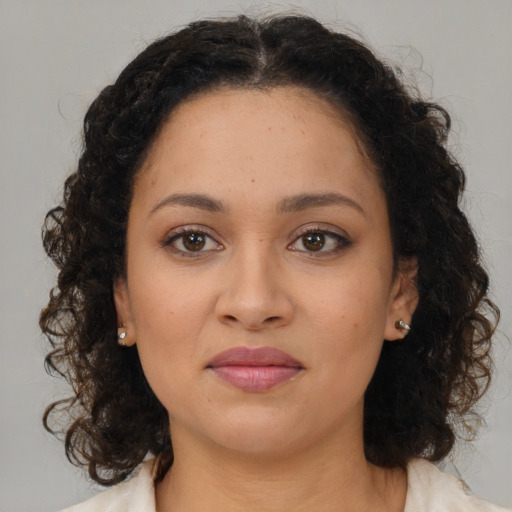 Joyful latino young-adult female with medium  brown hair and brown eyes