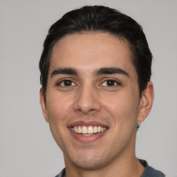 Joyful white young-adult male with short  black hair and brown eyes