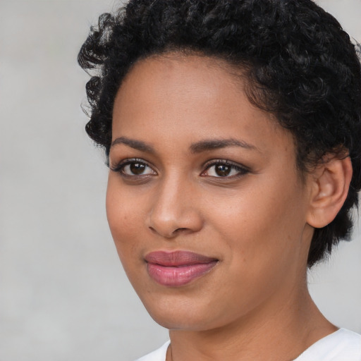 Joyful latino young-adult female with short  black hair and brown eyes
