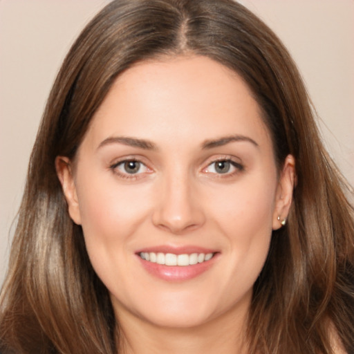 Joyful white young-adult female with long  brown hair and brown eyes